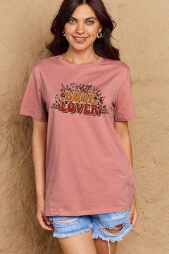 A pink t-shirt with 'Book Lover' printed in front of s mass of small flowers and stems