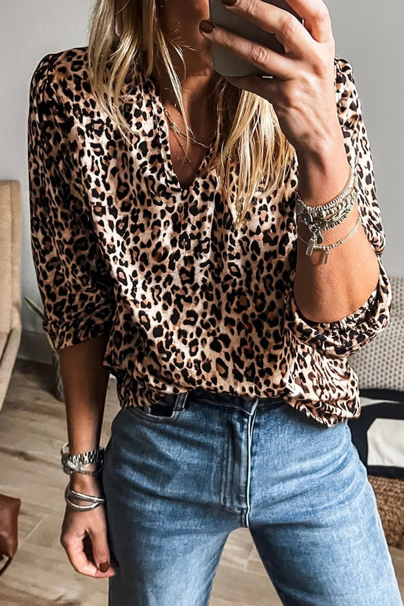 Leopard print pull over blouse with three quarter elastic banded sleeps and notched neck.