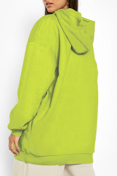 Person wearing a bright green hoodie on a white background