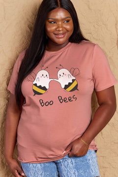 Woman wearing a pink t-shirt with 'Boo Bees' design against a beige background