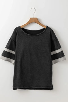 Black t-shirt with gray sleeves on a wooden hanger against a white background
