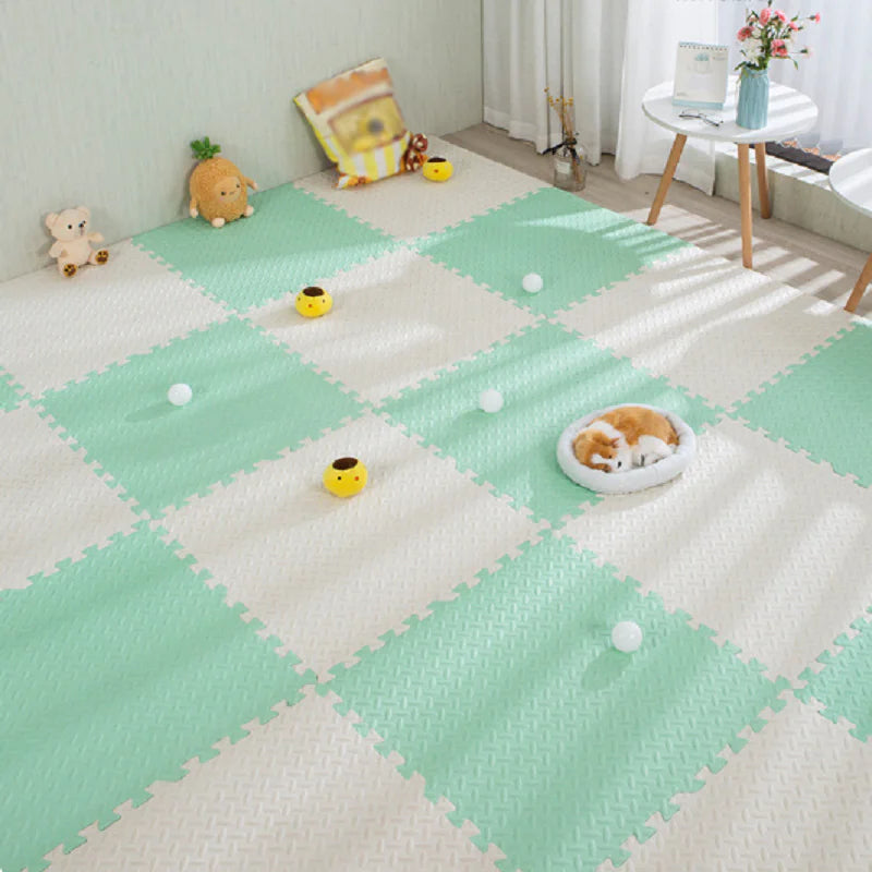 Children's play area with green and white checkered foam mats.