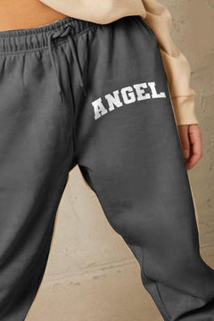 gray sweatpants with 'ANGEL' text at the top of the left leg in white block letters, cuffed pants and elastic waistband with drawstring