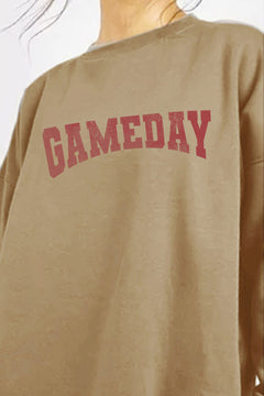 Beige sweatshirt with 'GAMEDAY' text in red on a plain background
