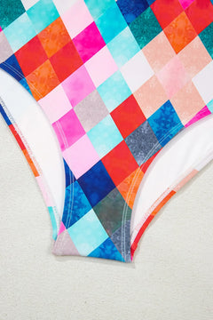 Close up of bottom detail on one piece bathing suit in colored diamond pattern