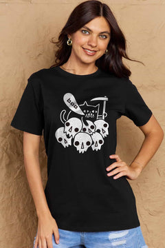 Black tshirt round neck with short sleeves and Halloween design of 6 white skulls below and outline of a cat saying boo and holding a scythe.