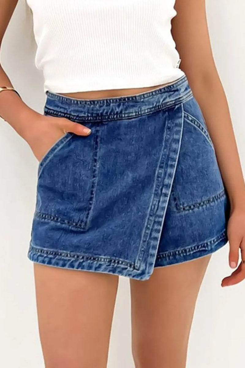 Dark Blue denim skort with front pockets and faded color around the hem and waistband