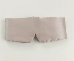 Silk sleep mask in a soft pink color on a light gray background