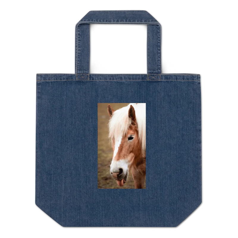 Denim tote bag with a pony's face , ears forward, tongue stuck out 