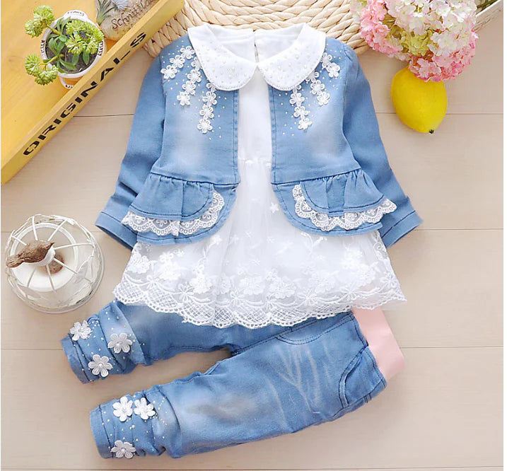 Girls 1-3 year denim and lace outfit with blue jeans and matching jean jacket to be worn over a lace tunic, trimmed in lace and daisies on the pants cuffs, pink elastic waist