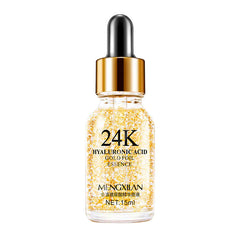 Bottle of 24K hyaluronic acid gold foil essence with gold cap on a white background