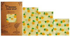 Set of beeswax food wraps with pineapple pattern and packaging on a white background