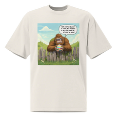White t-shirt with a cartoon design of a Sasquatch holding an Easter egg, bubble declares, Yep, Easter Bunny is good, but nobody is better than me at Hide N Seek!