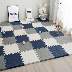 Checkered foam play mat on a wooden floor with toys and decor items.