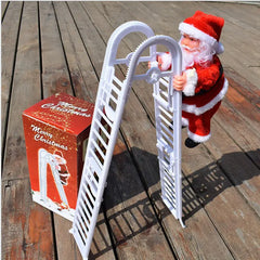 Santa Claus toy climbing a white ladder on a wooden surface with a Christmas-themed box.