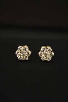 Gold and moissanite earrings on a black background