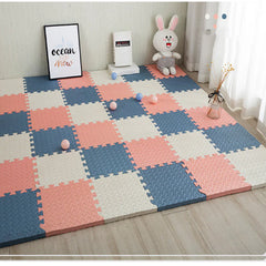 Checkered foam play mats on a wooden floor with toys and decor items.