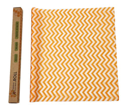 Orange and white zigzag patterned beeswax foodwrap cloth with a cardboard box labeled 'ROLL' on the left.