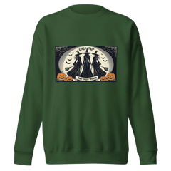 Green sweatshirt with Halloween-themed graphic saying Girls Trip Time to get wicked with three witches about to take off on brooms towards the full moon