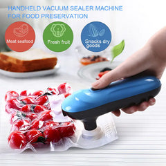 Handheld vacuum sealer machine being used to seal cherry tomatoes on a white surface with text about food preservation.