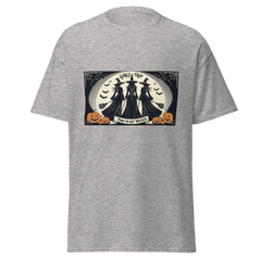 Gray t-shirt with Halloween-themed graphic of Three witches facing the full moon, brooms in had, stating GIrls Trip, Time to get Wicked