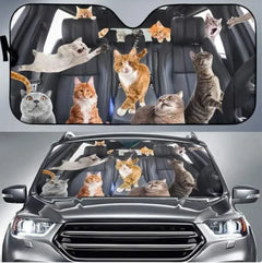 Car sunshade with cat designs on a car window