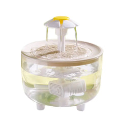 Cat water fountain with water flowing, clear bowl with white fountain head shaped like a daisy. 