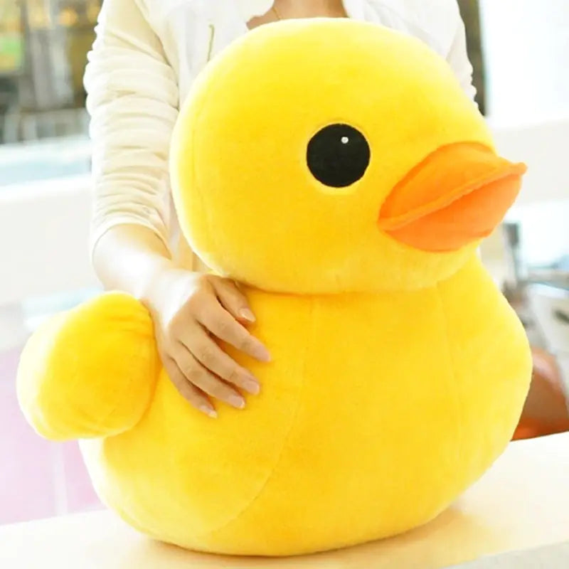 Large yellow rubber duck plush toy held by a person.