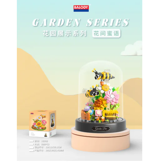 Garden-themed decorative item with bees and flowers inside a glass dome on a light background.
