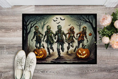 Halloween-themed doormat with zombies and pumpkins on a wooden floor.