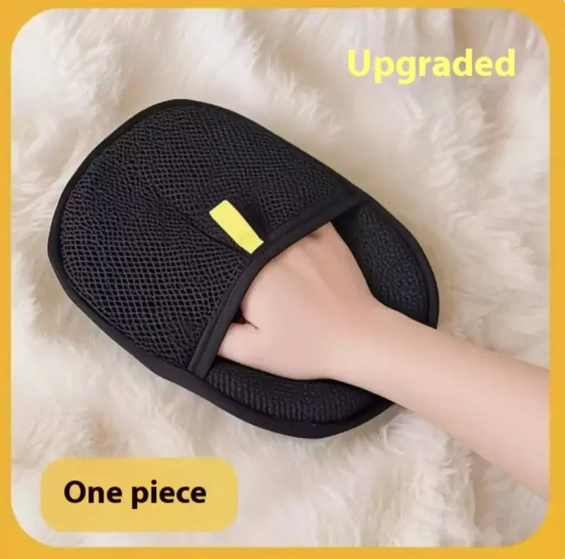 Black mesh grooming glove with a yellow tag on a white fluffy surface, labeled 'Upgraded One piece'.