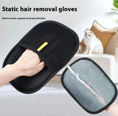 Black static hair removal gloves with a gray cleaning pad, used on a white surface with a cat in the background.