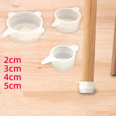 Silicone furniture leg extenders on a wooden surface with size measurements.