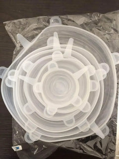 Set of clear silicone stretch lids on a dark surface