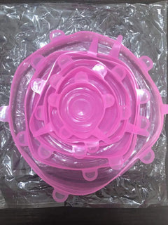 Pink silicone lid on a clear plastic sheet