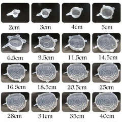 Silicone stretch lids of different sizes on a black background