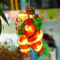 Decorative light-up Santa Claus figure with a blurred indoor background