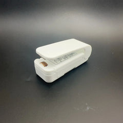 White mini resealer on a dark gray background