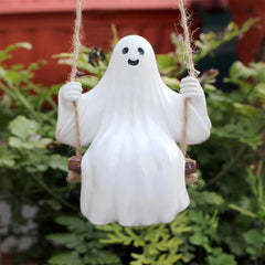 Ghost figurine on a swing with a blurred green background