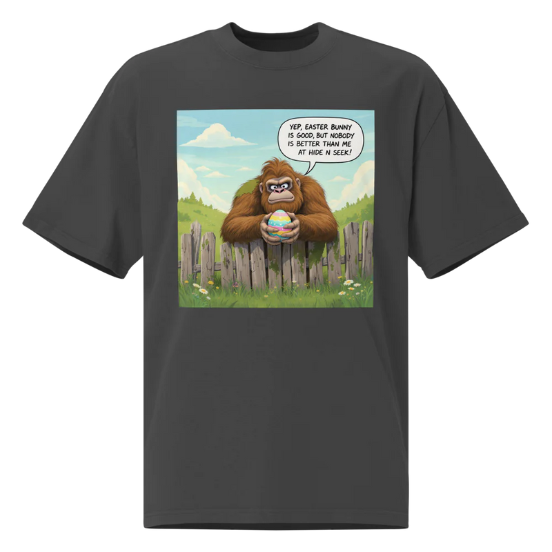 Black t-shirt with a cartoon design of a Sasquatch holding an Easter egg, bubble declares, Yep, Easter Bunny is good, but nobody is better than me at Hide N Seek!