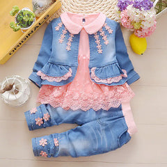 Girls 1-3 year denim and lace outfit with blue jeans and matching jean jacket to be worn over a lace tunic, trimmed in lace and daisies on the pants cuffs, pink elastic waist