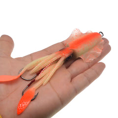 Fishing lure with orange and beige colors held in a hand against a white background