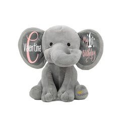 Gray elephant plush toy with personalized text on the ears. Baby name on one and my 1st Birthday on the other