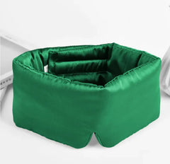 Green silk sleep mask on a white background