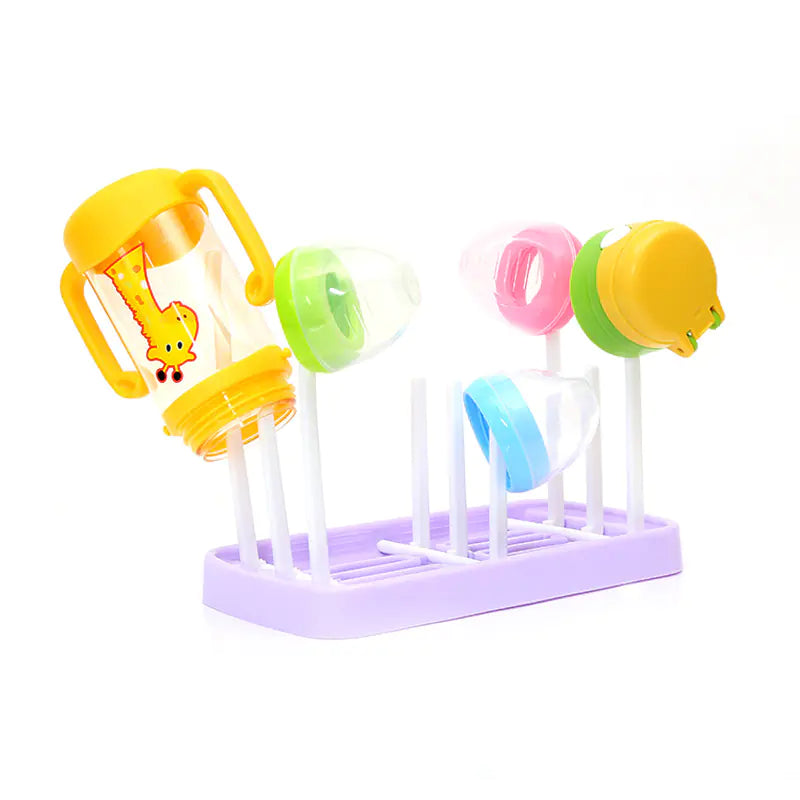 Colorful baby bottle drying rack with various bottles on a white background