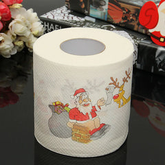 Roll of paper towel with Santa Claus and reindeer design on a dark surface.