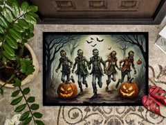 Halloween-themed doormat with zombies and pumpkins on a textured floor.