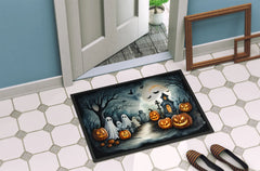 Halloween-themed doormat with pumpkins, ghosts, and a haunted house design on a tiled floor.