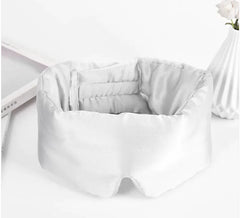 White sleep mask on a white surface with a minimal background