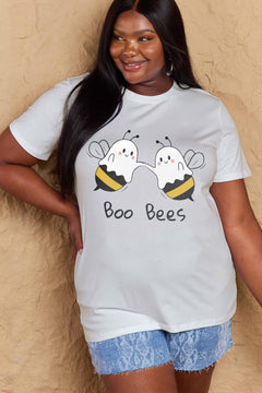 Person wearing a white t-shirt with 'Boo Bees' graphic design against a beige background